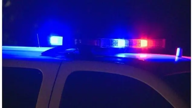 Police car with flashing red blue lights.