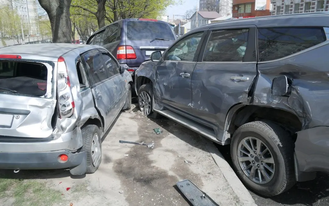 Two cars with significant damage after collision.