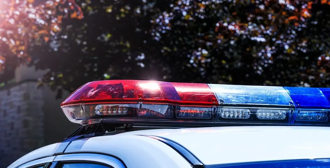 Police vehicle with flashing lights.