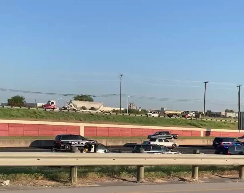 Truck accident on highway with police vehicles.