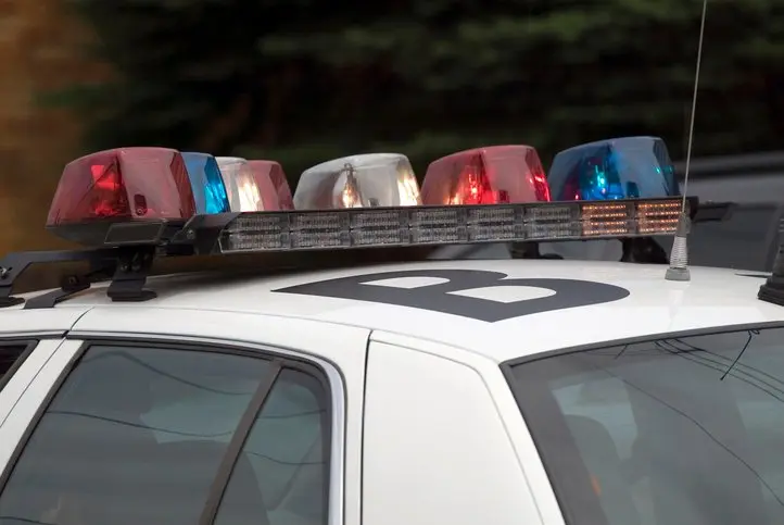 Police car with red and blue sirens.
