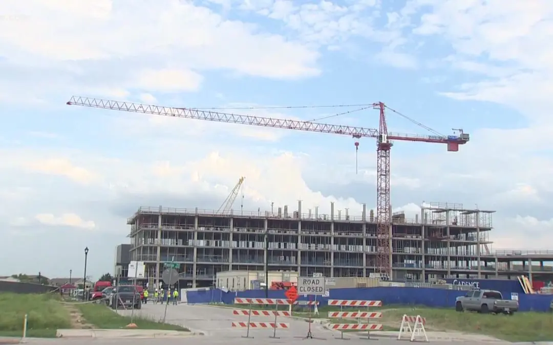 Construction site with a crane and barriers.