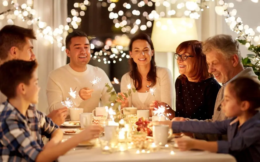Family celebrating with sparklers and festive decorations.
