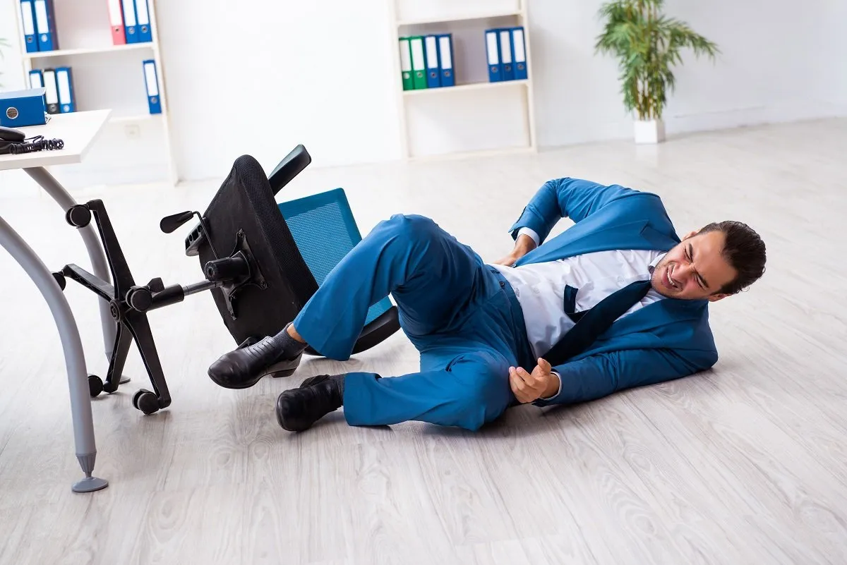 Man in blue suit injured from chair fall.