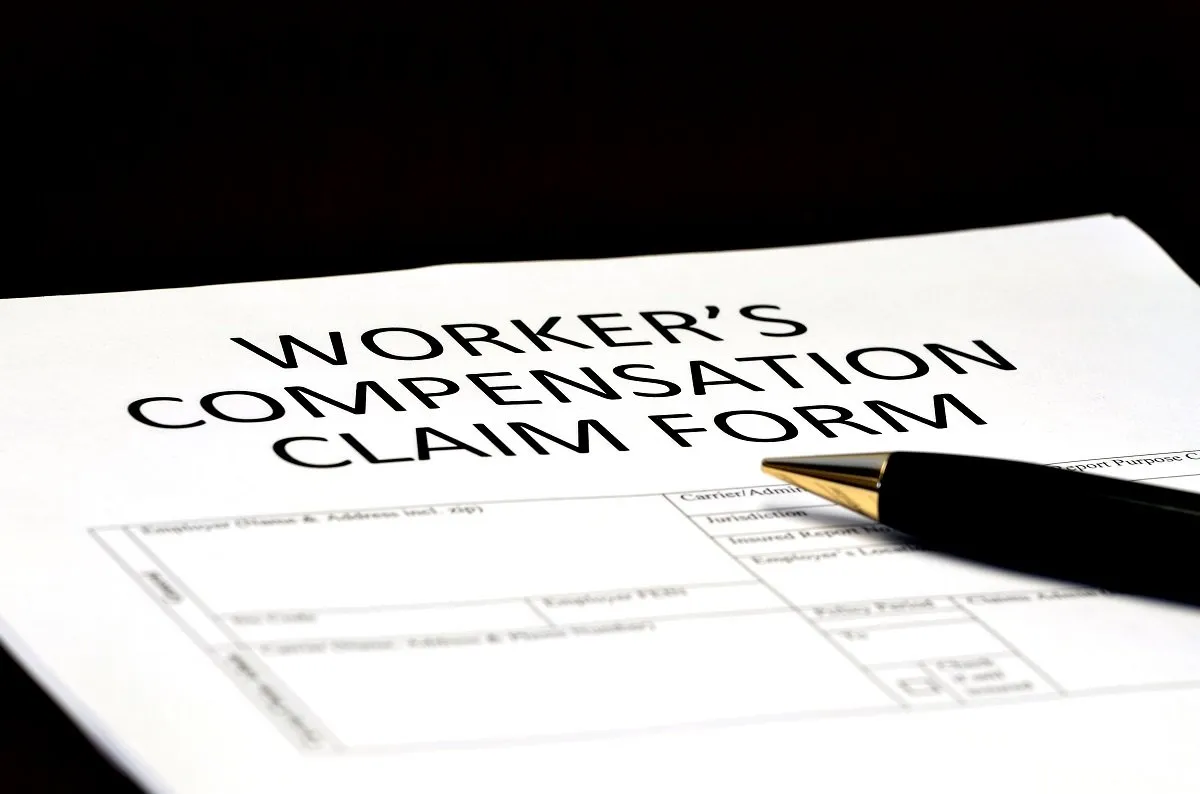 Worker’s compensation claim form with pen.