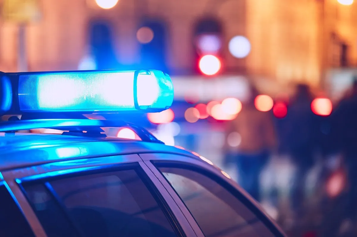 Police car with flashing lights at night.
