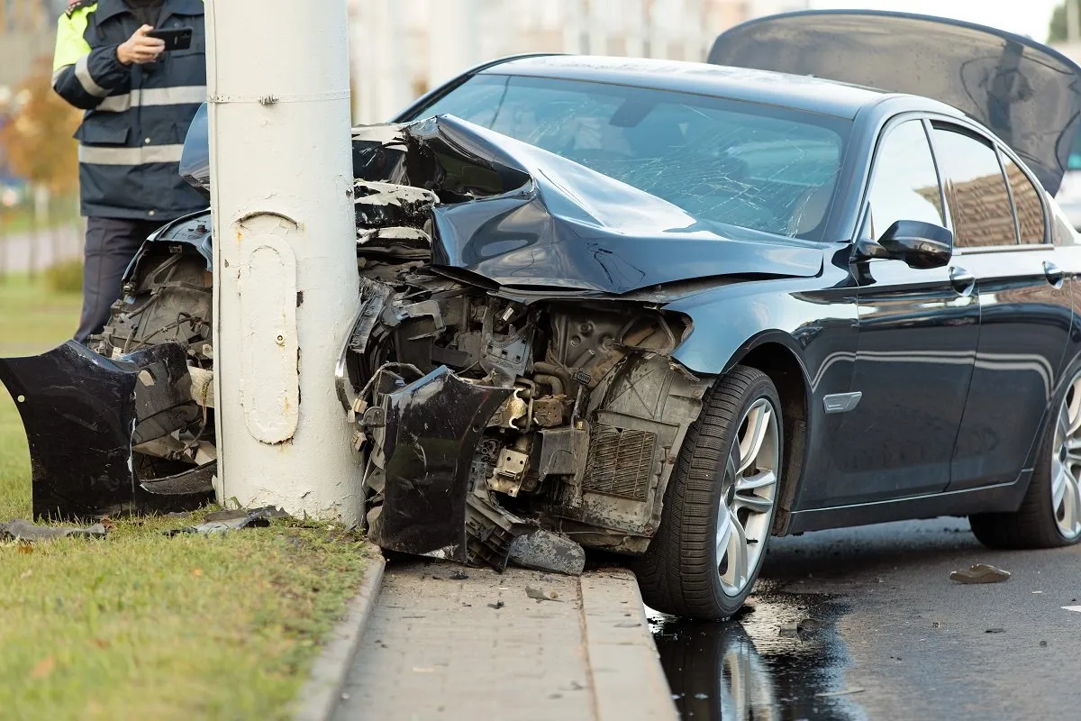 Car crashed into pole with front damage.