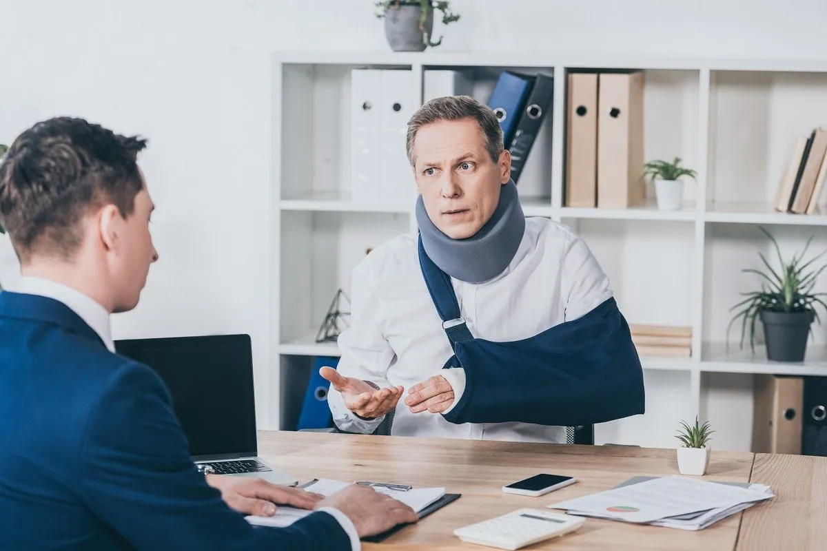 Injured man with a neck brace, discussing.