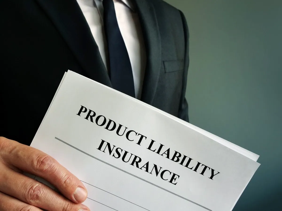 Man holding product liability insurance document.