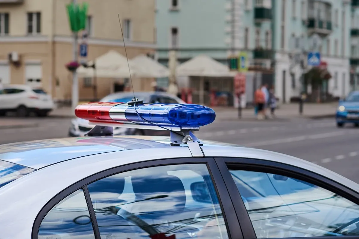 The roof and lights of a police car on a sunny day.