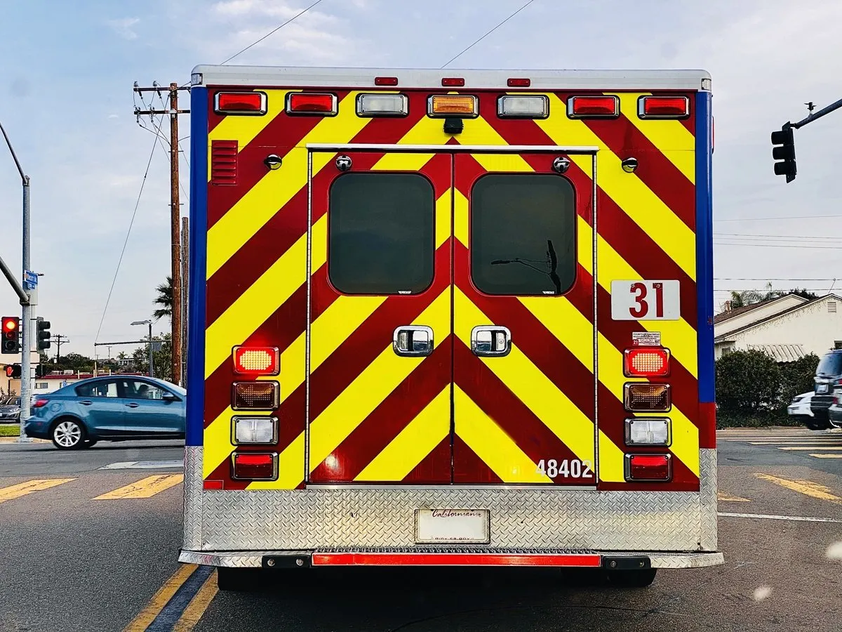 Rear view of ambulance with warning stripes.