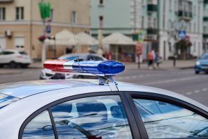 The roof and lights of a police car on a sunny day.