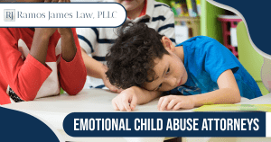 A sad little boy sitting at a school table with his head resting on his arm